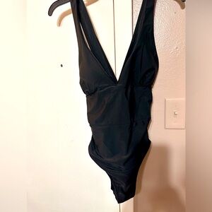 Women's one piece black swimsuit (crisscross back) brand new, never worn.